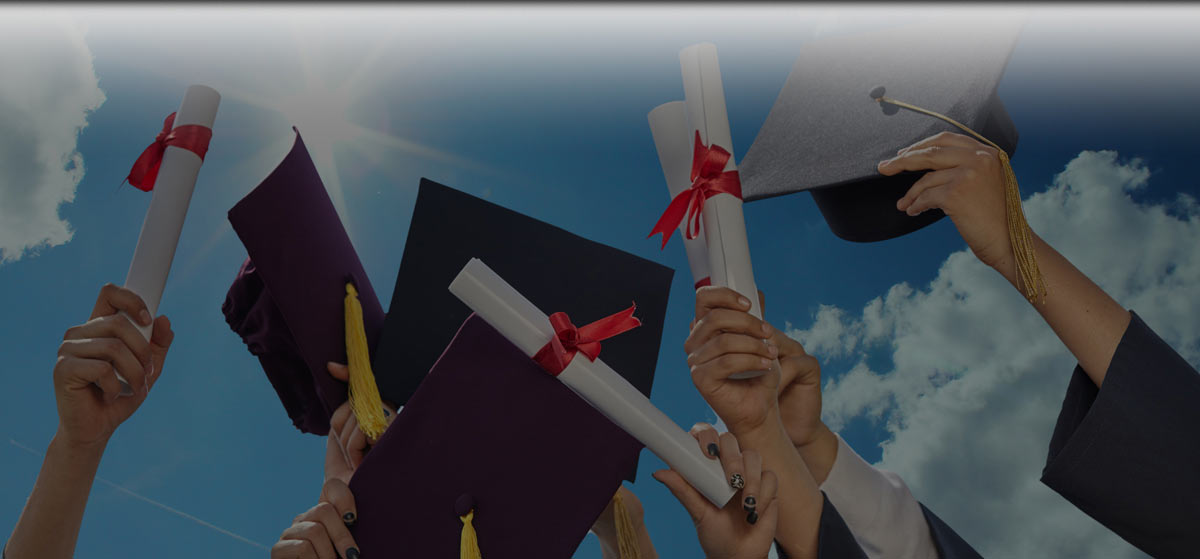 Students holding up caps and diplomas.
