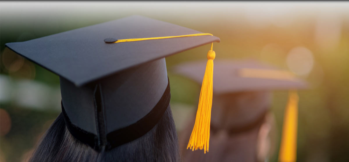 A graduate in a cap and gown.